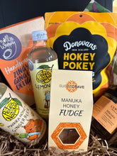 Load image into Gallery viewer, Assorted food products including honey, fudge, and lemon ginger beer in a gift box.