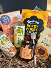 Load image into Gallery viewer, Assorted Manuka Honey products including choclate clusters, lemonade, cookies and fudge in a box