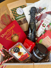 Load image into Gallery viewer, Assorted food items including a bottle, jars, and packets in a box.
