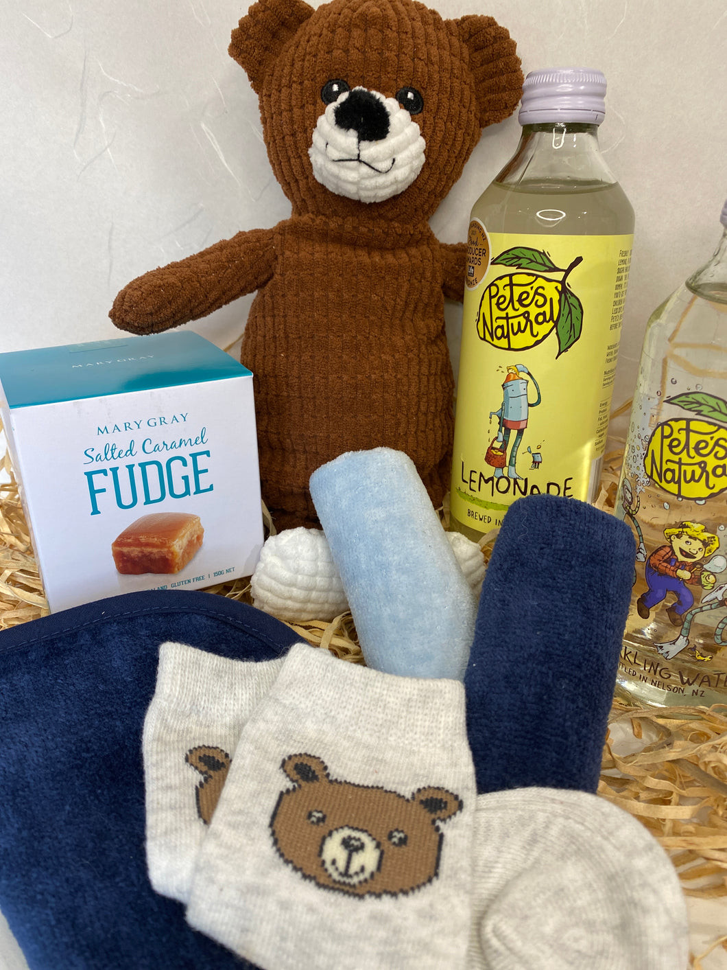 Brown cuddly bear toy and new baby boy gift box